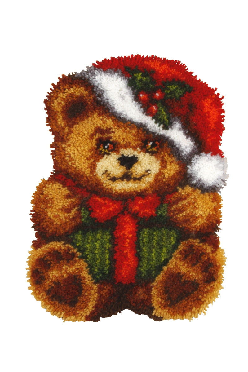 Latch hook cushion kit featuring a Christmas teddy bear design with vibrant yarn colors and printed canvas.